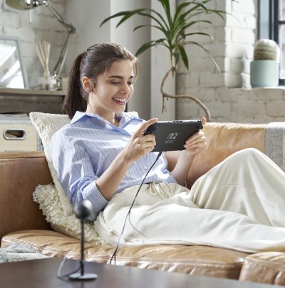 A girl playing Nintendo Switch 2 in handheld mode