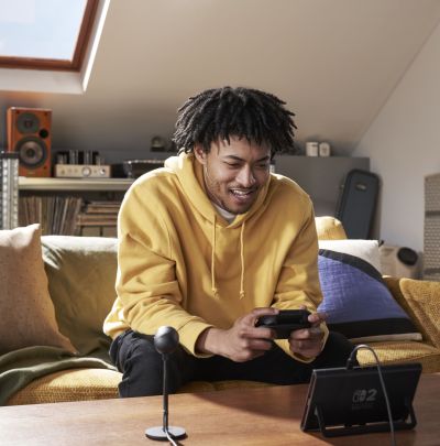 A boy playing Nintendo Switch 2 in tabletop mode